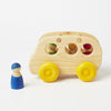 Grimm's wooden bus shown with 4 peg dolls 